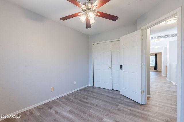 931 S Racine Ln, Gilbert, AZ 85296 - unfurnished bedroom with light wood-style floors, a closet, and ceiling fan