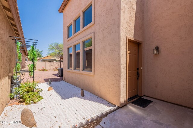 931 S Racine Ln, Gilbert, AZ 85296 - view of exterior entry featuring stucco siding and a patio area