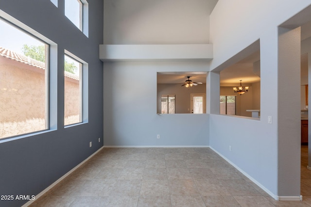 931 S Racine Ln, Gilbert, AZ 85296 - spare room with a chandelier, plenty of natural light, a towering ceiling, and light tile patterned floors