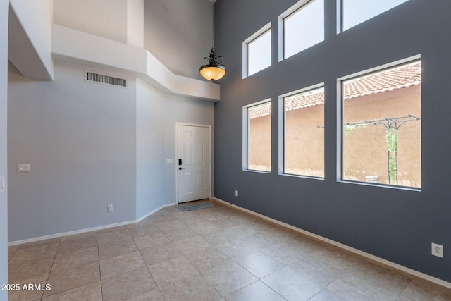 931 S Racine Ln, Gilbert, AZ 85296 - spare room with a towering ceiling and tile patterned flooring