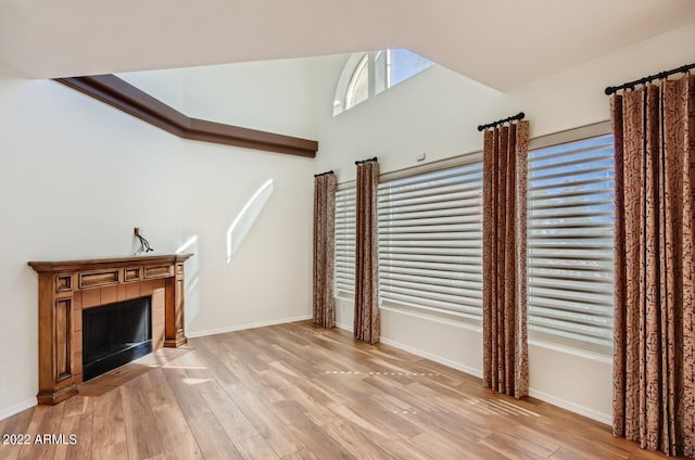 unfurnished living room with a fireplace and light hardwood / wood-style floors