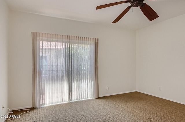 empty room with ceiling fan and carpet flooring