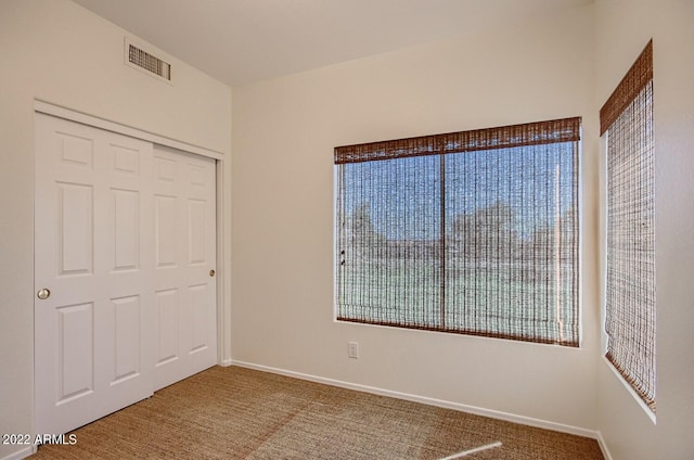 unfurnished bedroom with a closet and carpet flooring