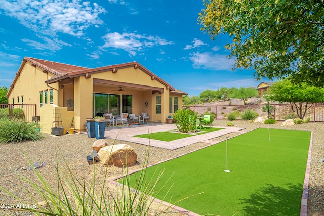 back of property featuring ceiling fan and a patio area