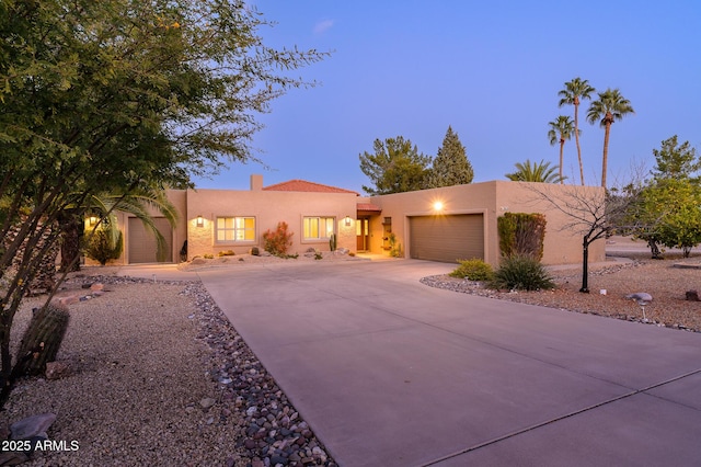 pueblo revival-style home with a garage