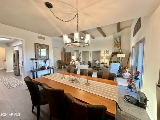 dining room featuring hardwood / wood-style floors, a notable chandelier, and beam ceiling