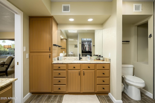 bathroom featuring vanity and toilet