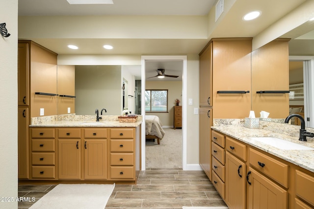 bathroom with ceiling fan and vanity