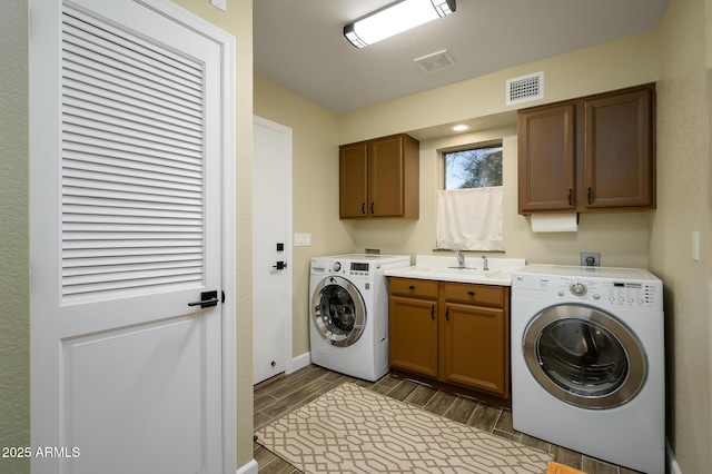 laundry room with electric dryer hookup, sink, cabinets, and washer hookup