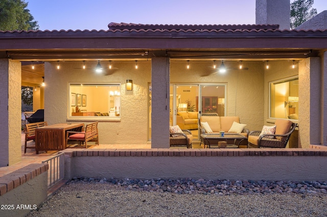 back house at dusk featuring an outdoor living space