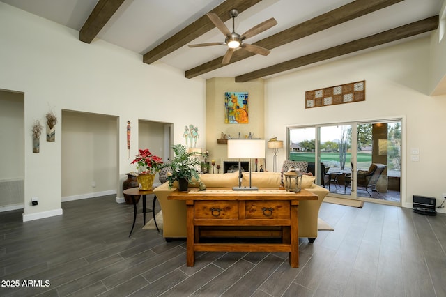 living room featuring beam ceiling and ceiling fan