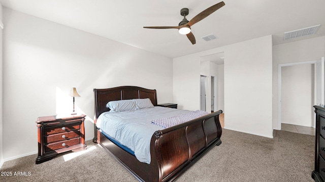 carpeted bedroom featuring visible vents and ceiling fan