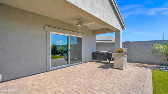 view of patio featuring ceiling fan, area for grilling, and fence