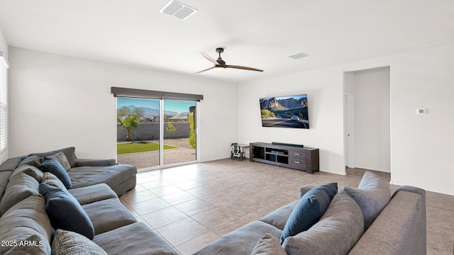 living area with ceiling fan, visible vents, and tile patterned floors