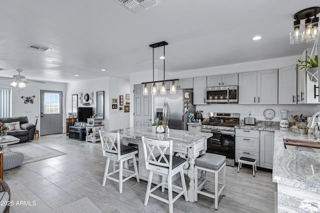 dining area featuring ceiling fan and sink