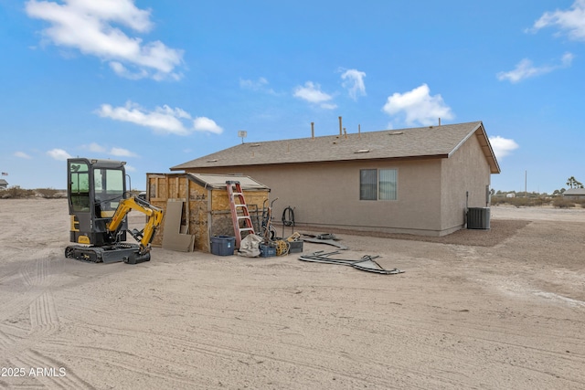 rear view of property featuring central air condition unit