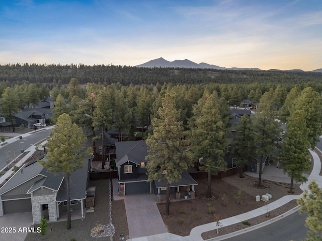 2395 S Polaris Way, Flagstaff, AZ 86001 - aerial view of property and surrounding area with a heavily wooded area, mountains, and nearby suburban area