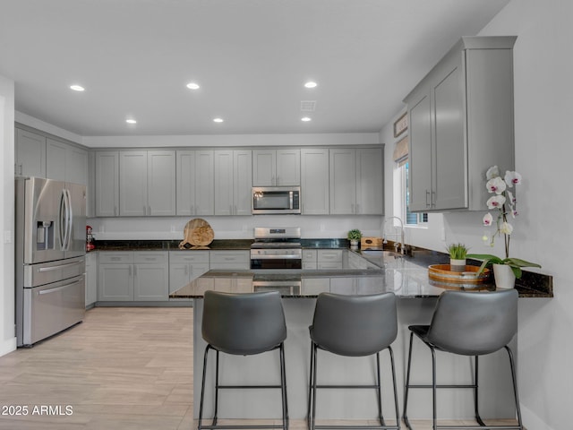 2395 S Polaris Way, Flagstaff, AZ 86001 - kitchen with appliances with stainless steel finishes, a sink, a peninsula, gray cabinets, and recessed lighting