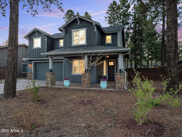 2395 S Polaris Way, Flagstaff, AZ 86001 - view of front of home with a porch, board and batten siding, an attached garage, and concrete driveway