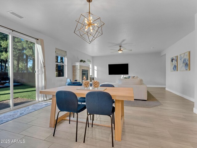 2395 S Polaris Way, Flagstaff, AZ 86001 - dining room with a ceiling fan, a glass covered fireplace, and baseboards