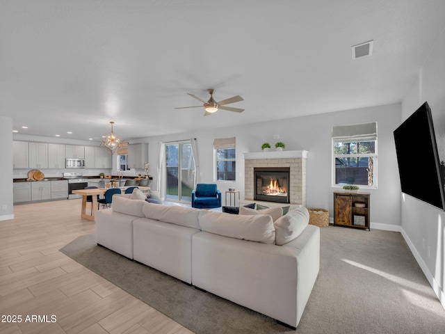 2395 S Polaris Way, Flagstaff, AZ 86001 - living room featuring ceiling fan, a fireplace, recessed lighting, baseboards, and light wood-type flooring