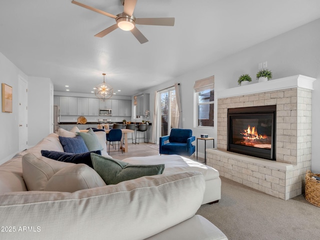 2395 S Polaris Way, Flagstaff, AZ 86001 - living room featuring a chandelier, ceiling fan, a brick fireplace, recessed lighting, and light carpet