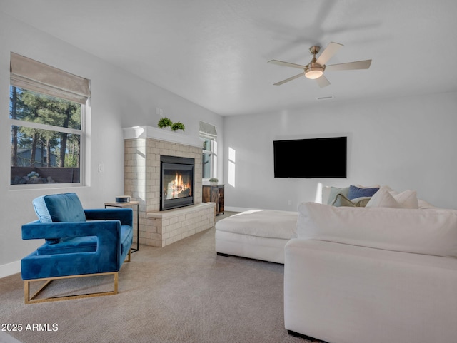 2395 S Polaris Way, Flagstaff, AZ 86001 - living area featuring plenty of natural light, a fireplace, a ceiling fan, and carpet