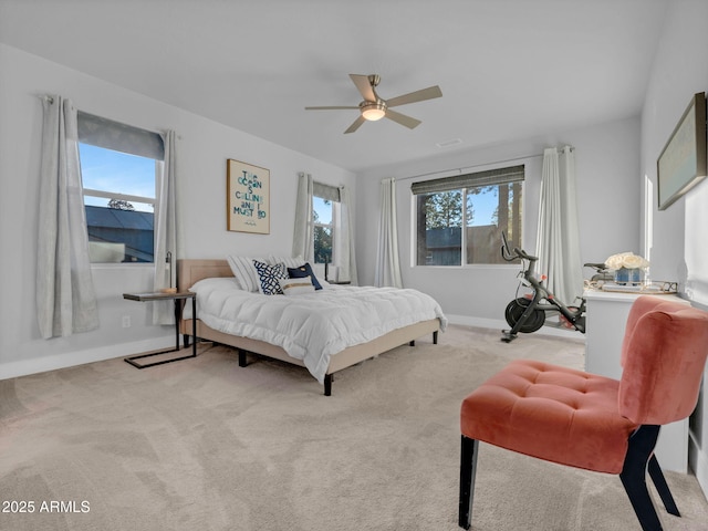 2395 S Polaris Way, Flagstaff, AZ 86001 - bedroom featuring multiple windows, light colored carpet, baseboards, and a ceiling fan
