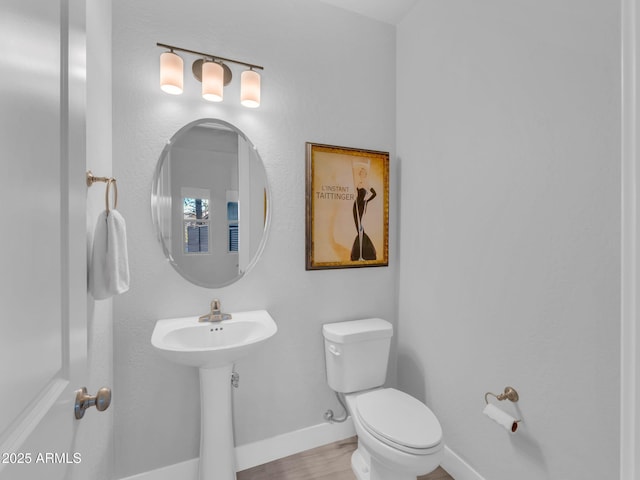 2395 S Polaris Way, Flagstaff, AZ 86001 - bathroom featuring toilet, baseboards, wood finished floors, and a sink