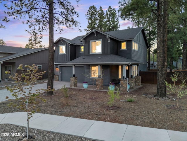 2395 S Polaris Way, Flagstaff, AZ 86001 - view of front of house with a porch, a garage, driveway, and board and batten siding