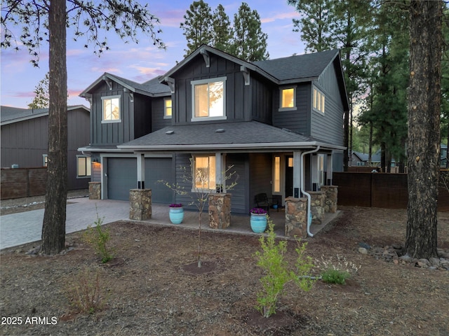 2395 S Polaris Way, Flagstaff, AZ 86001 - view of front of property featuring driveway, board and batten siding, a porch, and roof with shingles