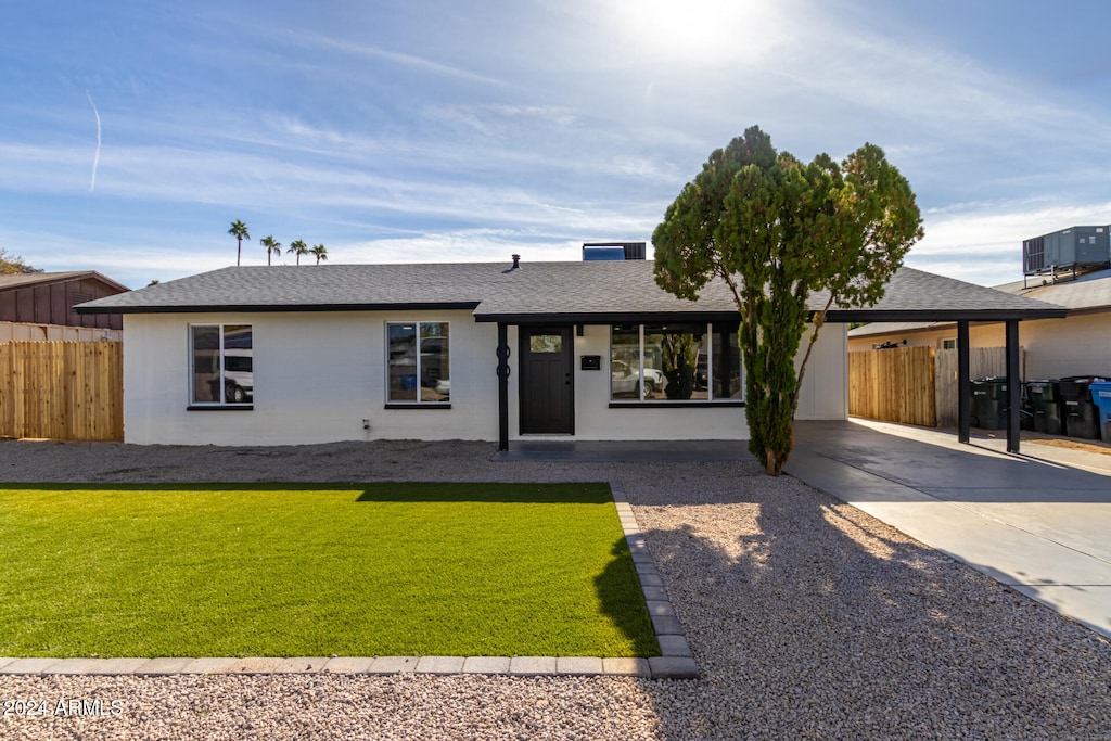 single story home featuring a front yard and cooling unit