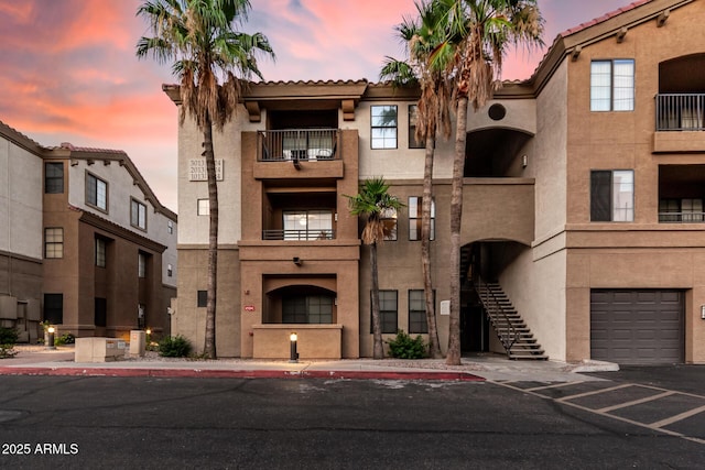5302 E Van Buren St Unit 2024, Phoenix, AZ 85008 - view of building exterior with stairway and a garage