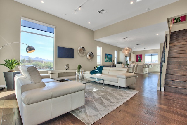 living room featuring a chandelier, a wealth of natural light, and dark hardwood / wood-style flooring