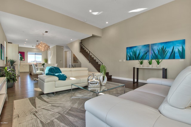 living room featuring an inviting chandelier and dark hardwood / wood-style flooring