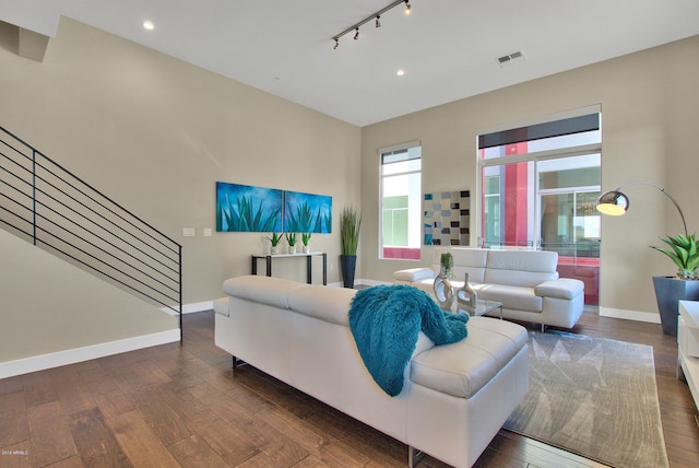 living room with track lighting and dark hardwood / wood-style flooring