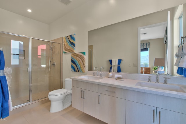 bathroom featuring dual sinks, tile flooring, toilet, large vanity, and walk in shower