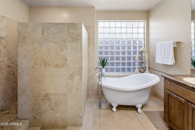 bathroom featuring tile patterned flooring, a freestanding bath, vanity, and a walk in shower