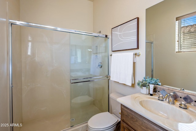 bathroom with vanity, toilet, and a shower stall