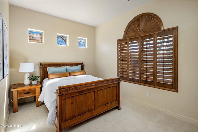 bedroom featuring baseboards and light carpet