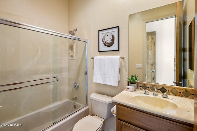 full bathroom with vanity, toilet, and bath / shower combo with glass door