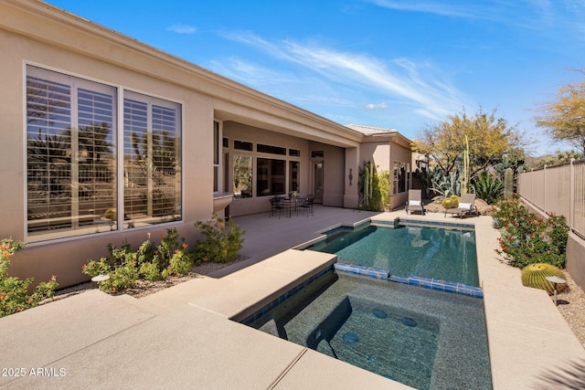 view of swimming pool featuring an in ground hot tub, a patio area, and fence