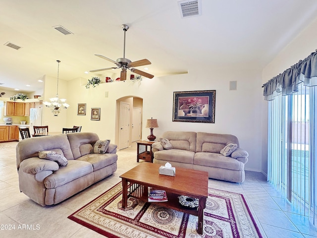 living room with light tile patterned floors and ceiling fan with notable chandelier