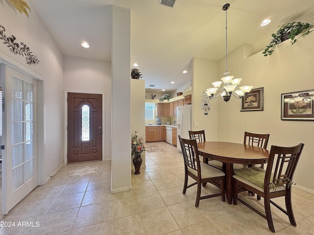 tiled dining room featuring a chandelier