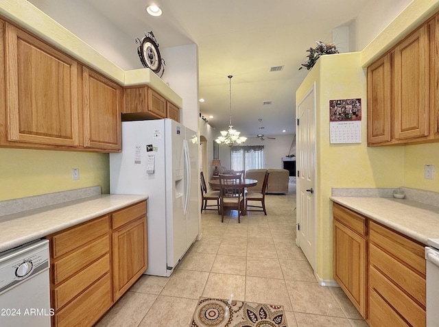 kitchen featuring light tile patterned floors, ceiling fan with notable chandelier, hanging light fixtures, and white appliances