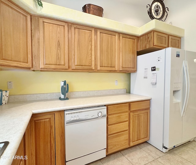 kitchen featuring white appliances and light tile patterned flooring