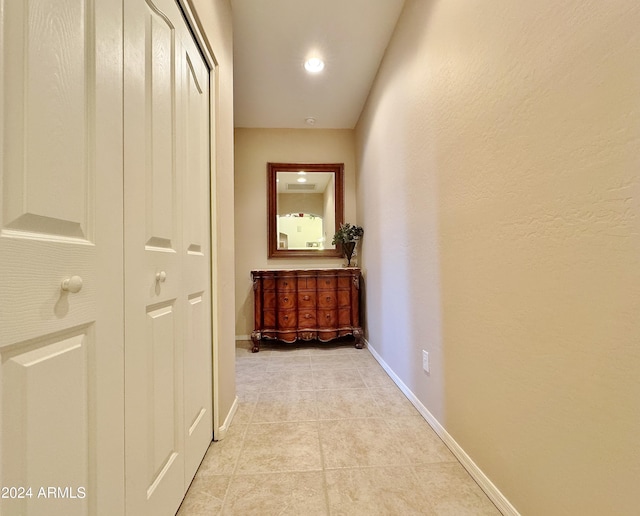 hallway featuring light tile patterned floors