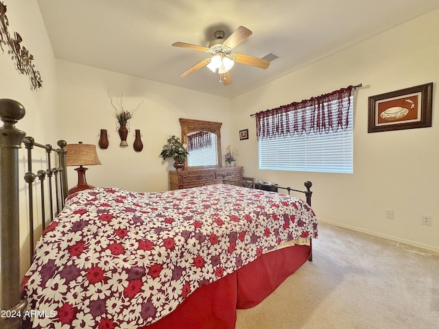 bedroom with multiple windows, ceiling fan, and carpet floors