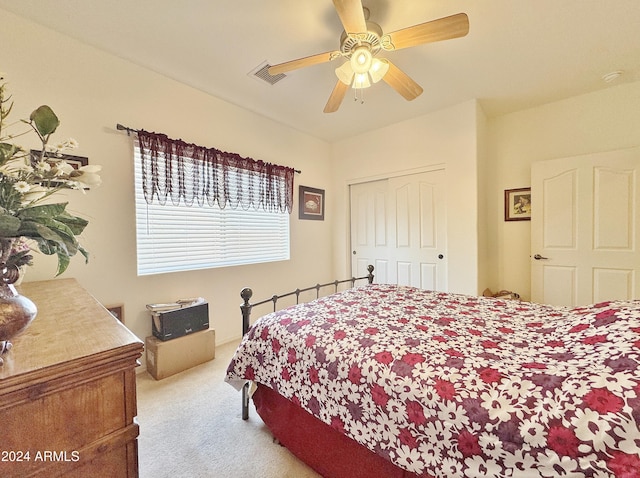 carpeted bedroom with a closet and ceiling fan