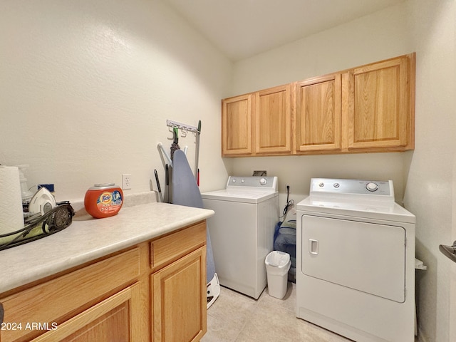 laundry room with cabinets and separate washer and dryer